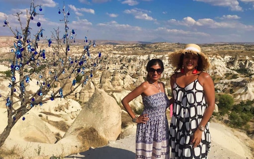 Cappadocia landscape with evil eye tree and Uchisar Castle in the background.