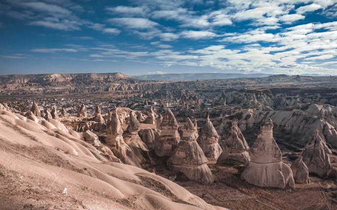 Cappadocia rock formations under a blue sky, South Cappadocia Day Tour.