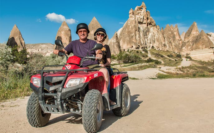 Quad bike riders exploring Cappadocia's unique rock formations.