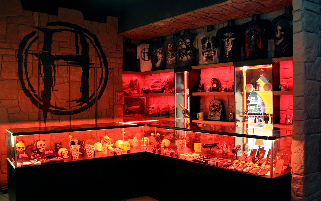 Merchandise display with skulls and horror-themed items at Hysteria Haunted Attraction, Dubai Mall.