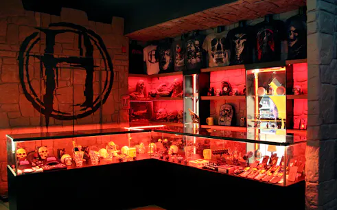 Merchandise display with skulls and horror-themed items at Hysteria Haunted Attraction, Dubai Mall.