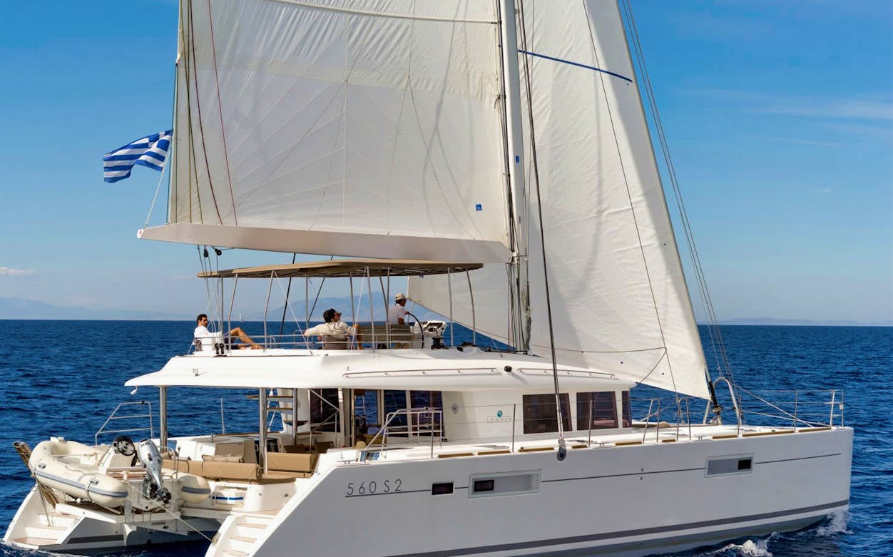 Sailing catamaran on the Aegean Sea during Santorini Ultimate Sailing Cruise Experience.