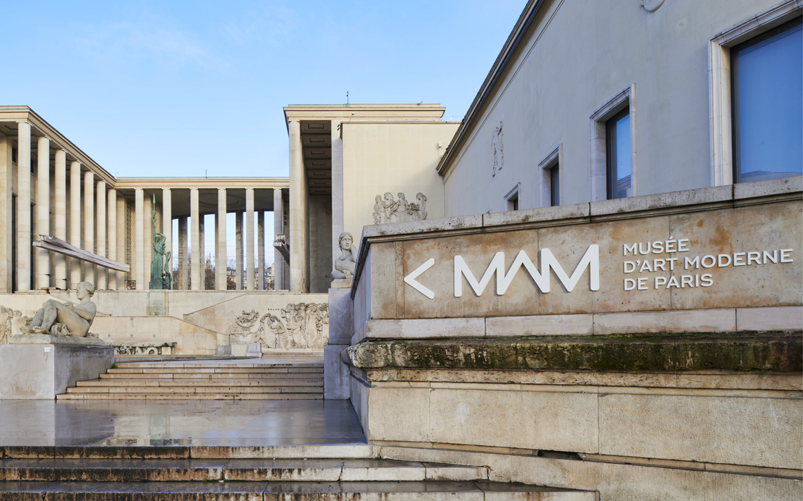 Paris Museum of Modern Art entrance with sculptures and columns.