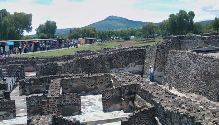 Teotihuacan pyramids with tourists exploring, Tlatelolco ruins, and Guadalupe Shrine in Mexico City tour.