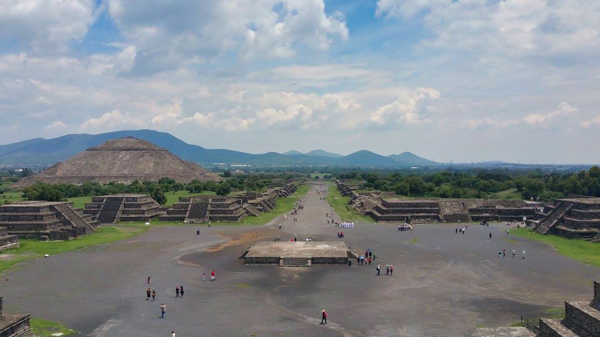 Teotihuacan pyramids with tourists exploring, Tlatelolco ruins, and Guadalupe Shrine in Mexico City tour.