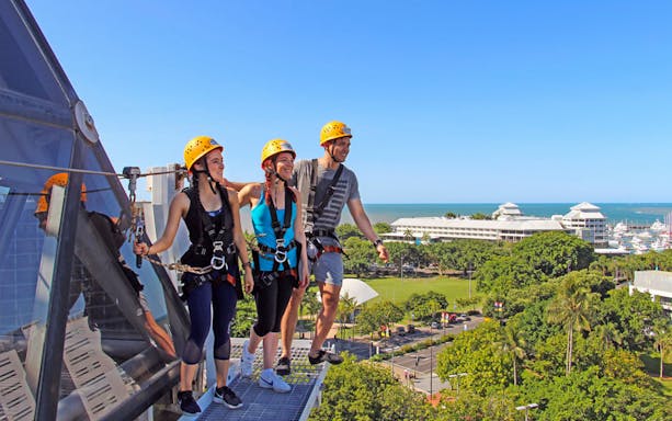 Visitors on a high ropes course at Cairns Zoom & Wildlife Dome with city and ocean view.