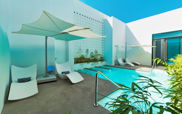 Private pool area at Nikki Beach Resort & Spa Dubai with lounge chairs and umbrellas.
