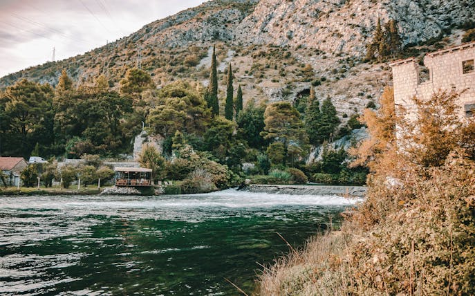 Riverside view with trees and hills on Dubrovnik History & Scenery City Tour.