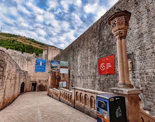 Dubrovnik Old Town stone walls with banners, part of Game of Thrones Walking Tour.
