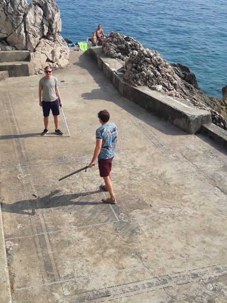 Tourists reenact sword fight on Dubrovnik's Game of Thrones driving tour.