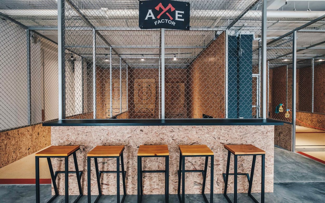 Axe throwing lanes with wooden targets at Axe Factor in Singapore.