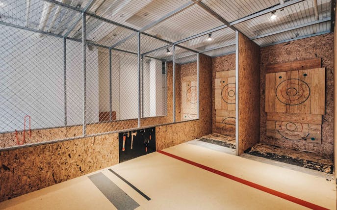 Axe throwing lanes with wooden targets in Singapore.