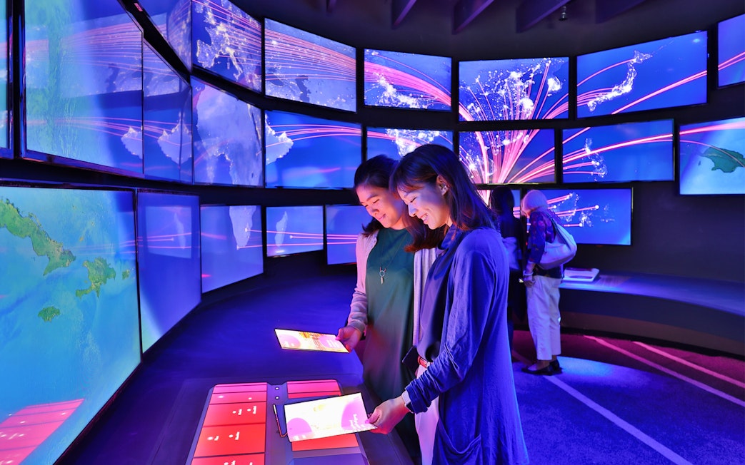 Visitors interacting with digital displays at Changi Experience Studio, Singapore.
