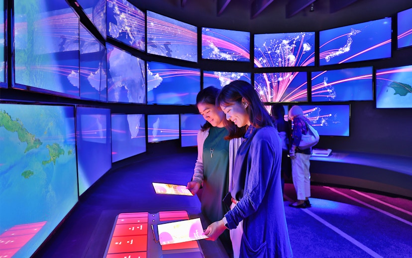 Visitors interacting with digital displays at Changi Experience Studio, Singapore.