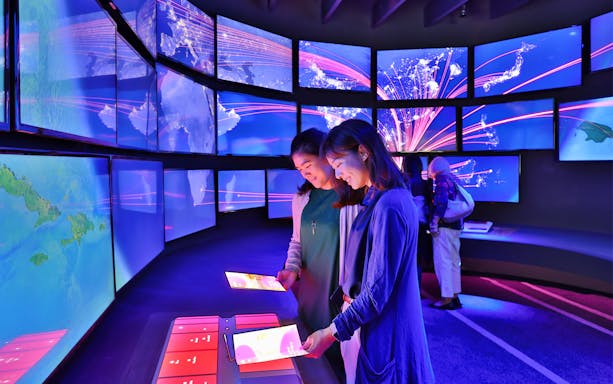 Visitors interacting with digital displays at Changi Experience Studio, Singapore.
