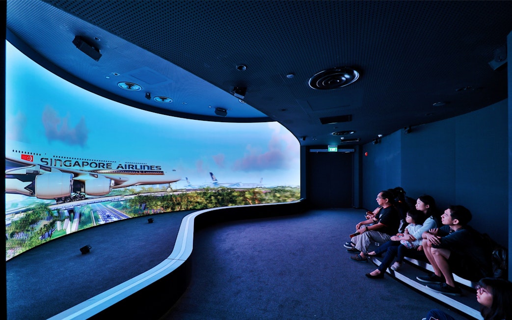 Visitors watching a Singapore Airlines simulation at Changi Experience Studio.