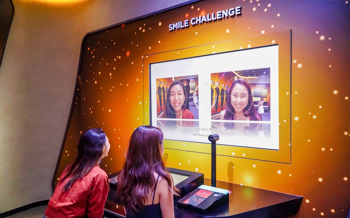 Visitors participating in the Smile Challenge at Changi Experience Studio.