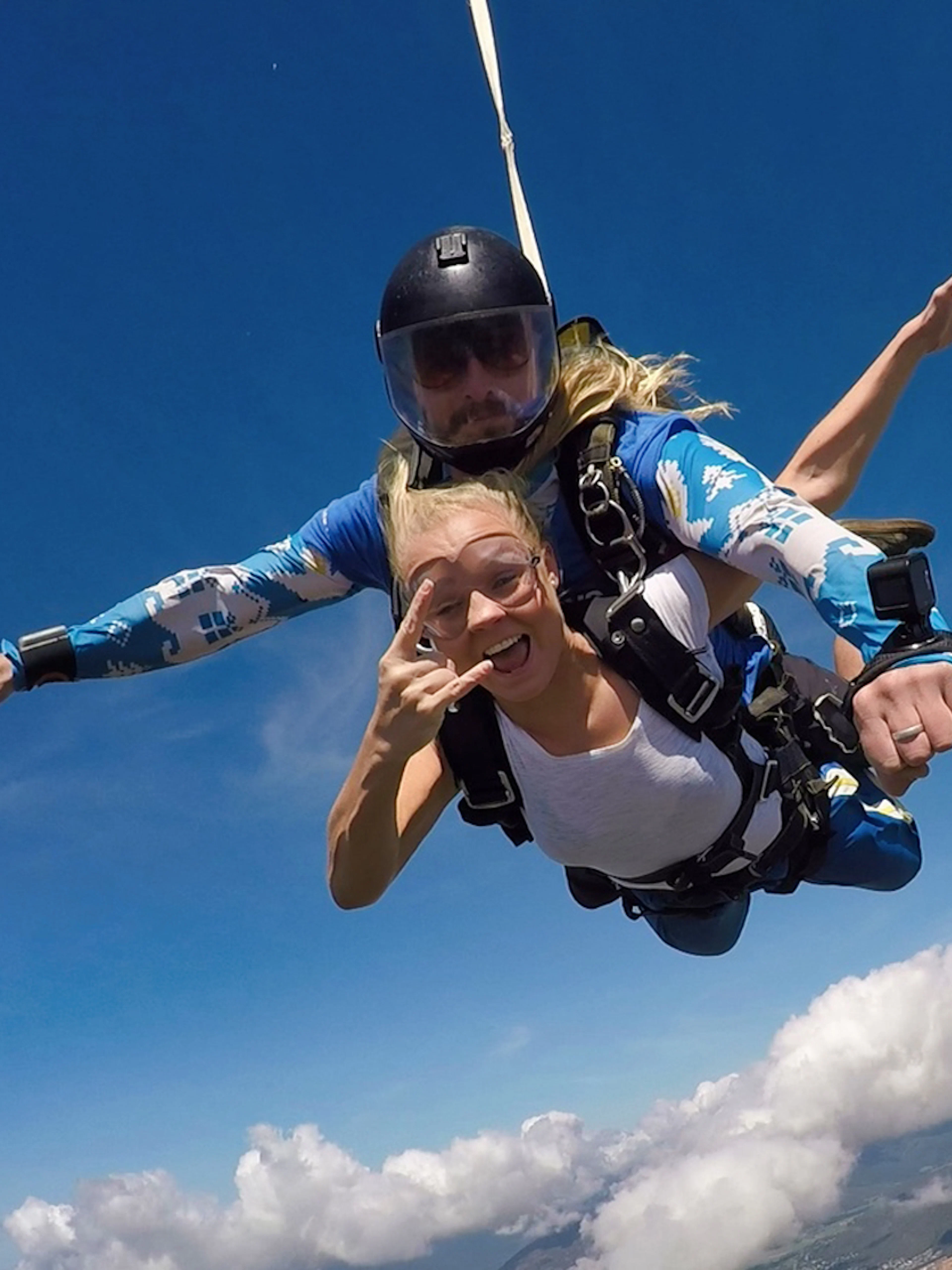 Tandem skydive over Cairns at 15,000ft with scenic view of clouds and landscape below.