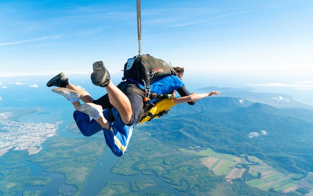 Tandem skydive over Cairns with views of coastline and rainforest below.