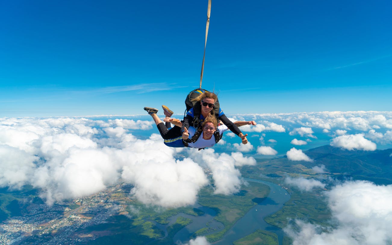 Tandem skydive over Cairns with ocean and landscape views below.