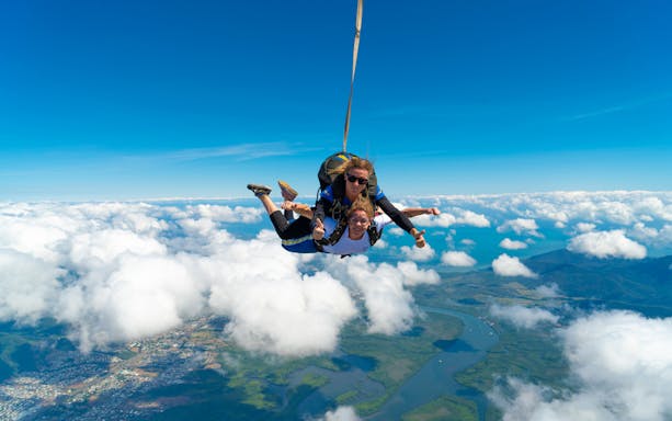 Tandem skydive over Cairns with ocean and landscape views below.