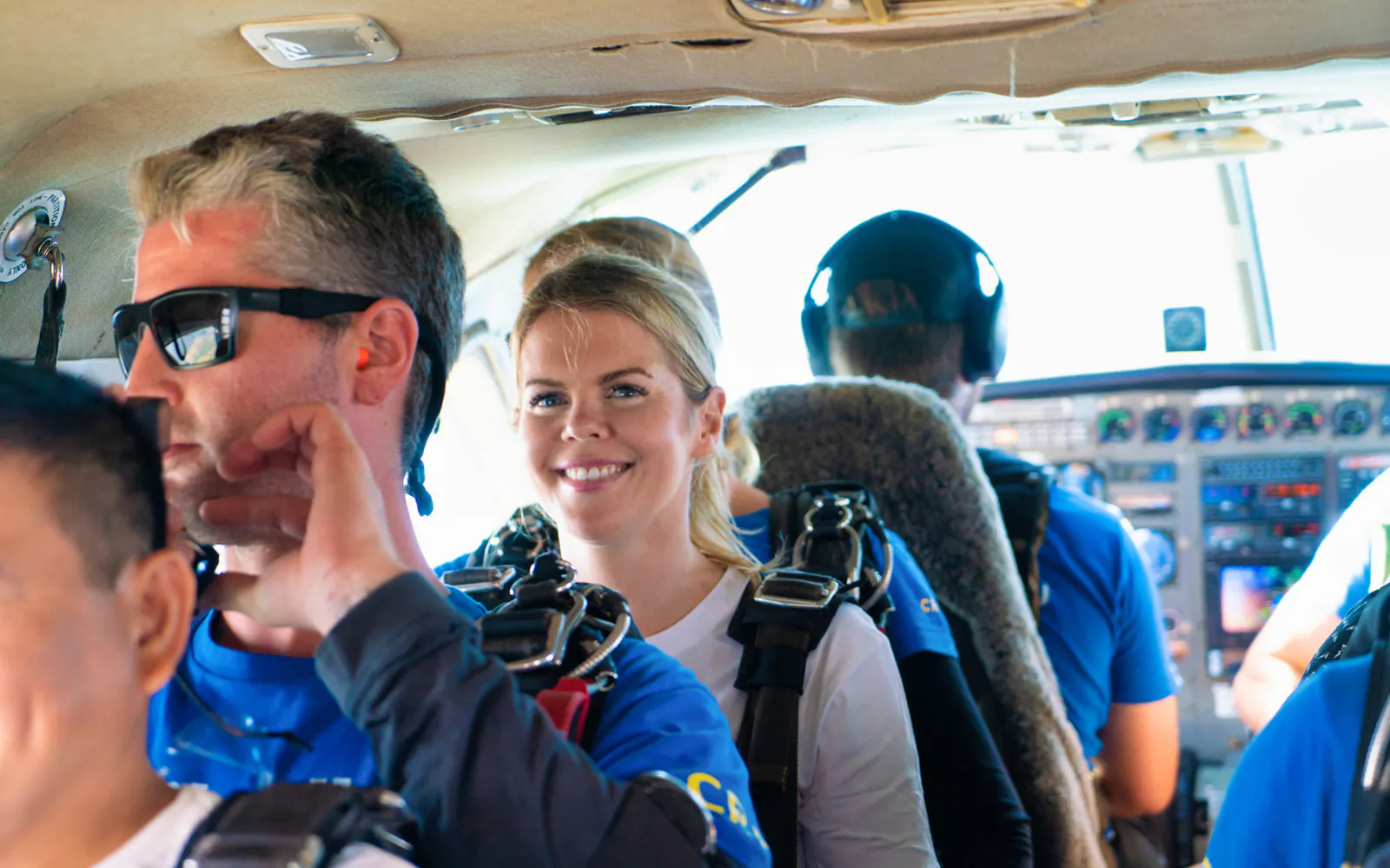 Skydivers preparing for 15,000ft tandem jump in Cairns airplane.