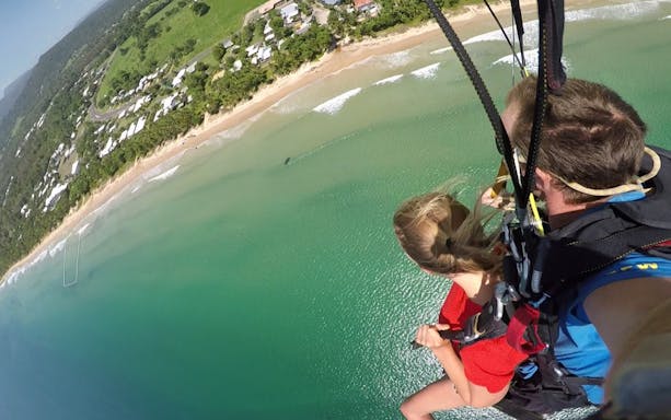 Tandem skydive over Mission Beach, Australia, with ocean and coastline view.