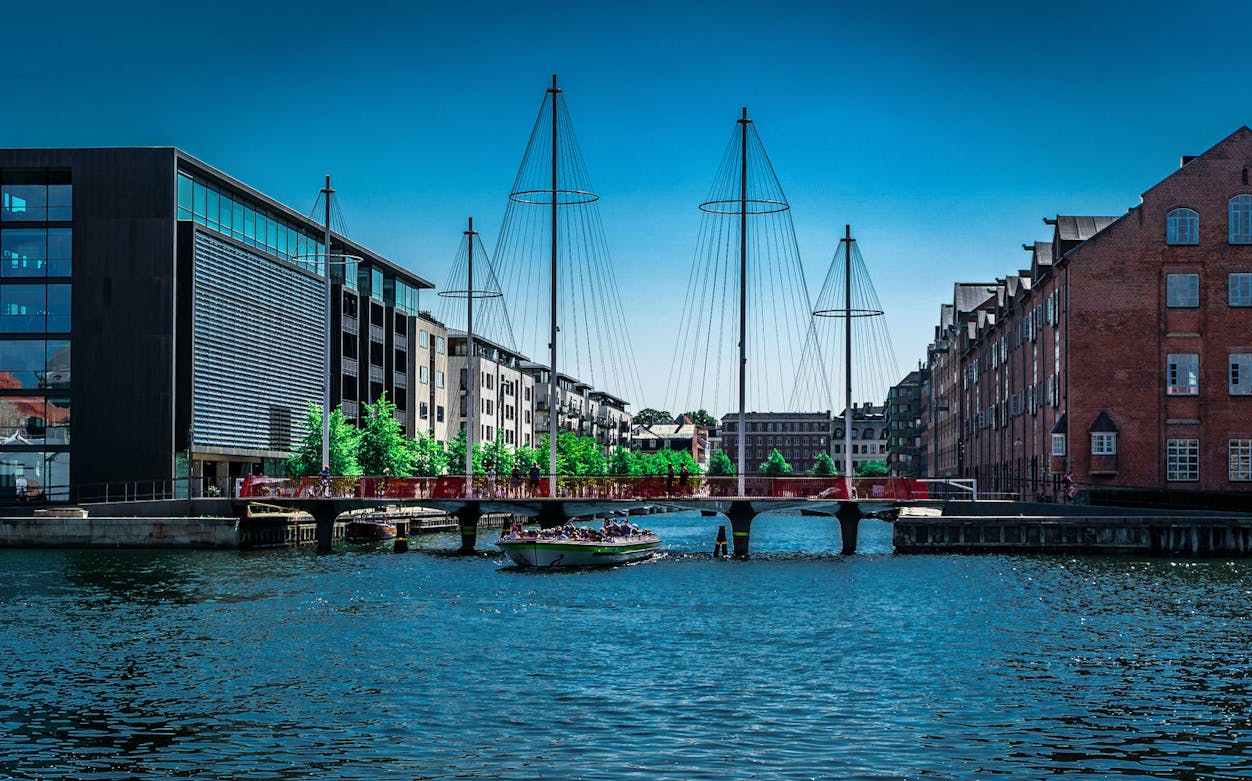 Cyclists crossing the Circle Bridge over a canal in Copenhagen.