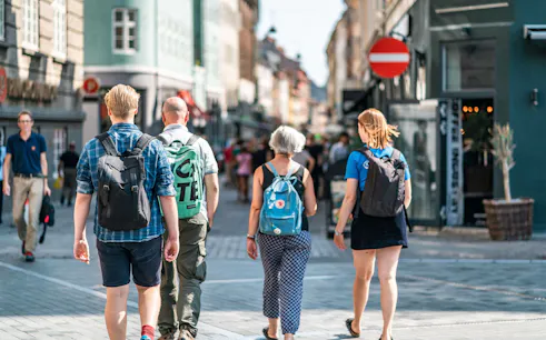 Tourists walking on a bustling street in Copenhagen during a city walking tour.