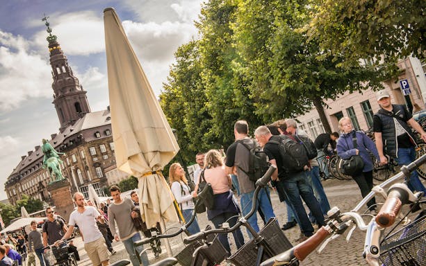 Group of tourists near Christiansborg Palace on a Copenhagen city walking tour.