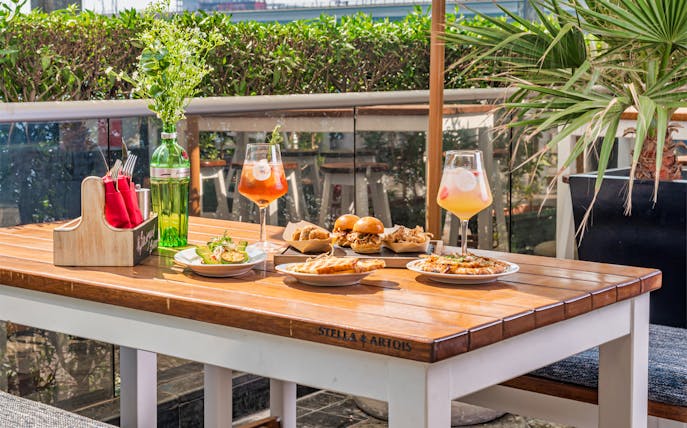 Outdoor dining setup with appetizers and drinks at JW Marriott Marquis Dubai.