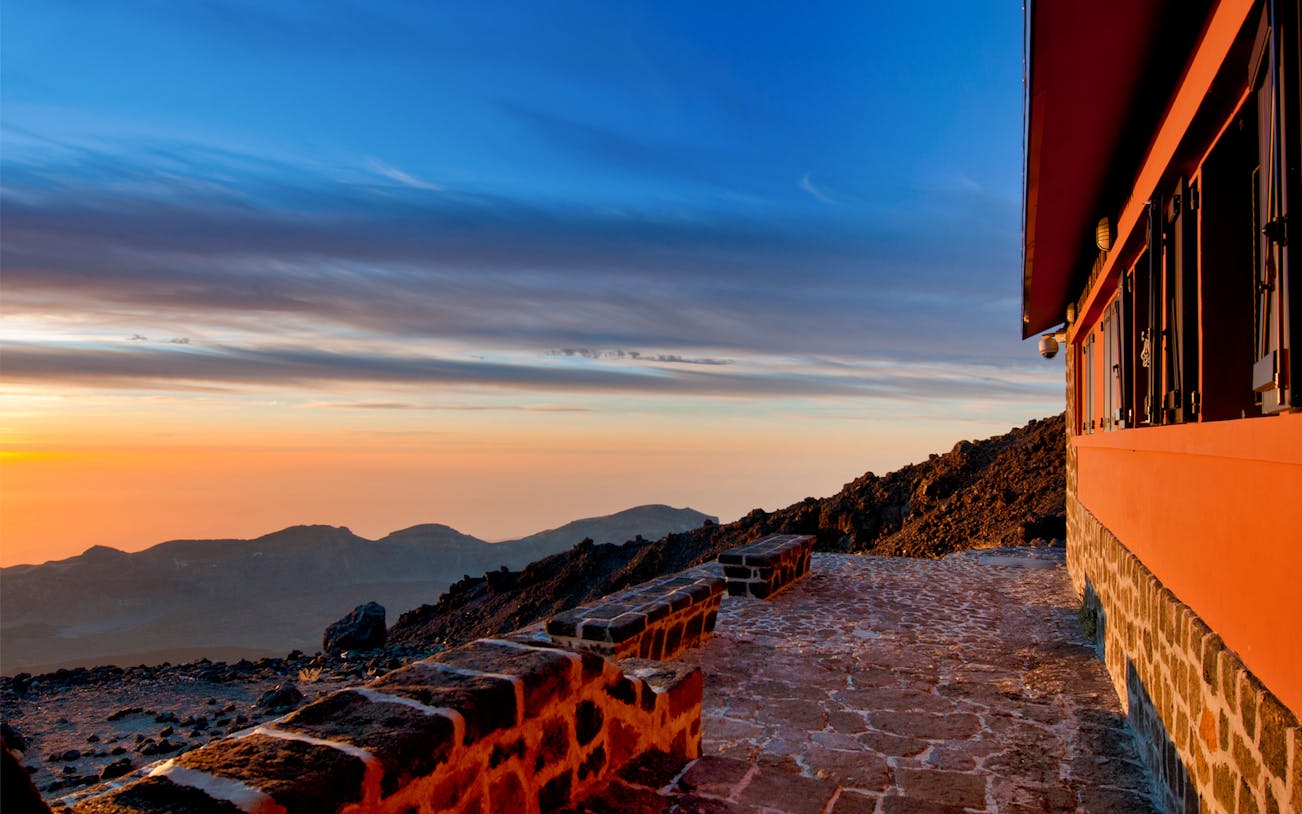 Teide National Park landscape at sunset with stone path and building, Tenerife.