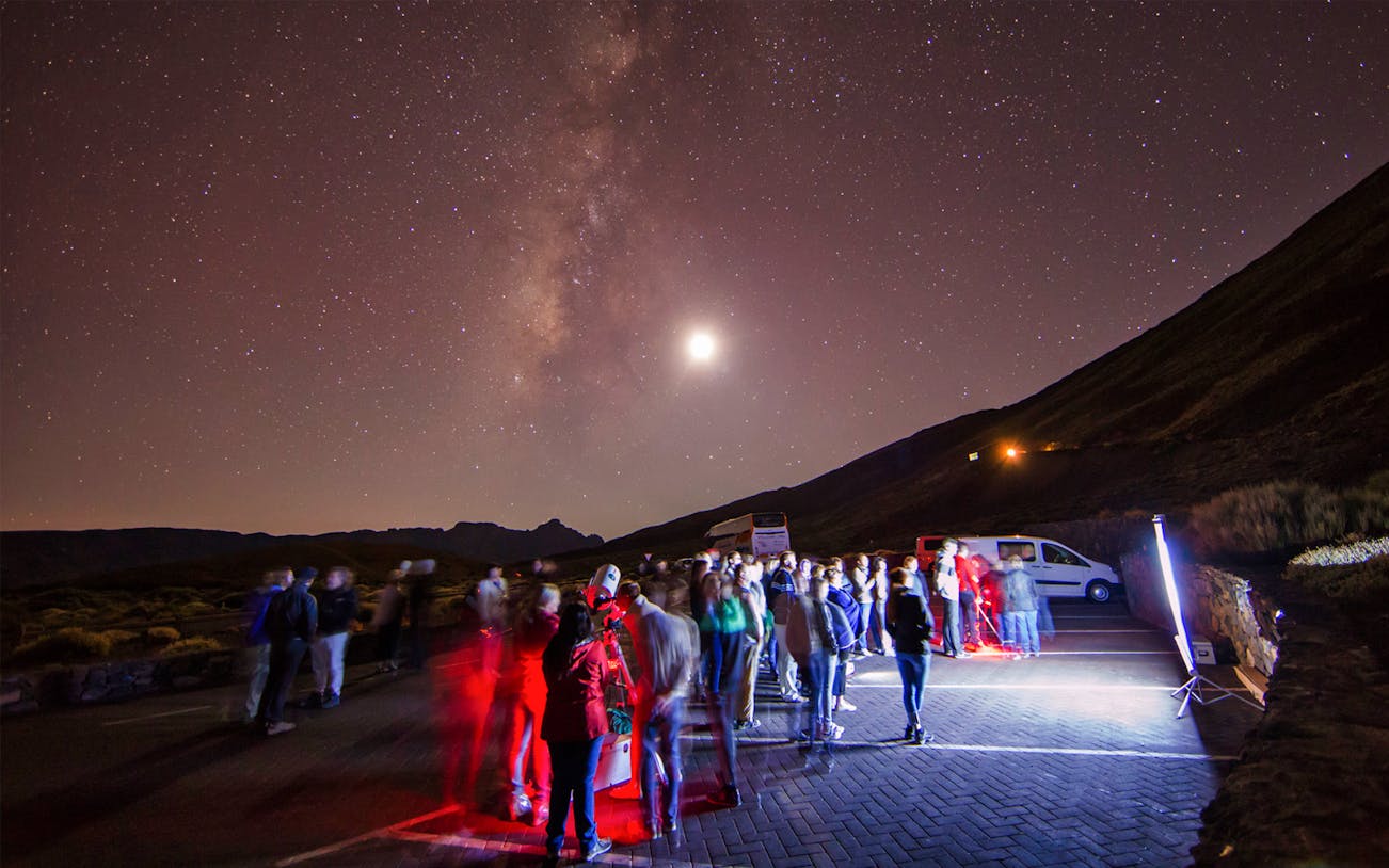 Group stargazing under Milky Way on Teide Astronomic Tour, Tenerife.