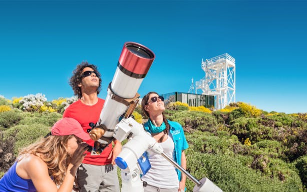 Visitors using a telescope for stargazing at Mount Teide Observatory, Tenerife.