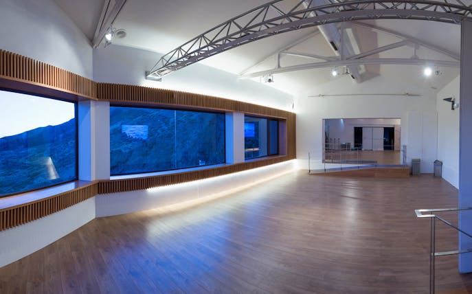 Observatory interior with large windows overlooking Mount Teide landscape.