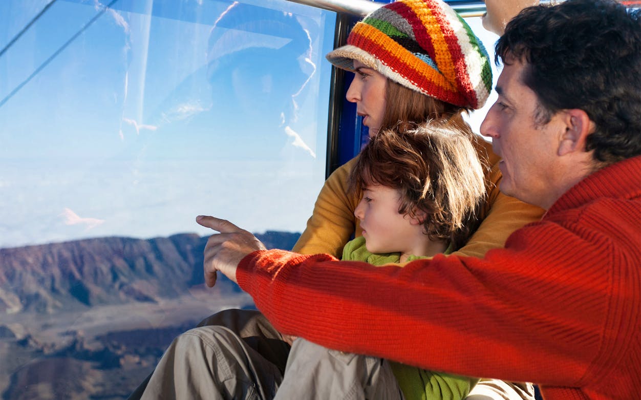 Family enjoying Mount Teide views from cable car, Tenerife.