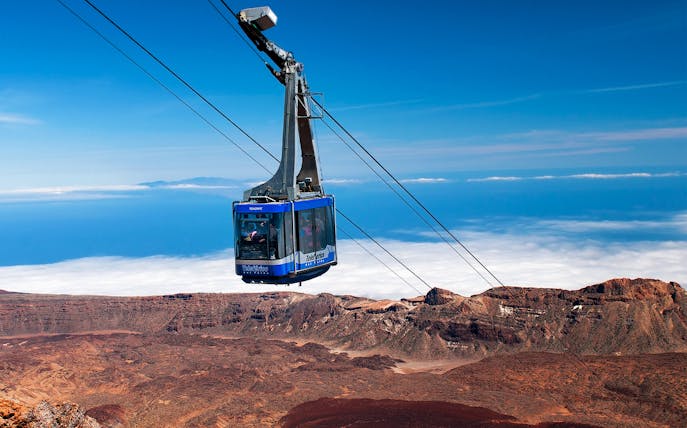 Cable car ascending Mount Teide with scenic volcanic landscape in Tenerife.