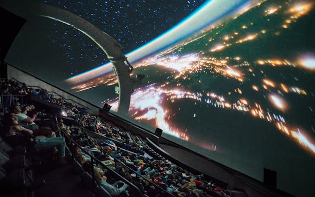 Visitors watching a space-themed film at Hemisfèric 3D Cinema in Valencia, Spain.