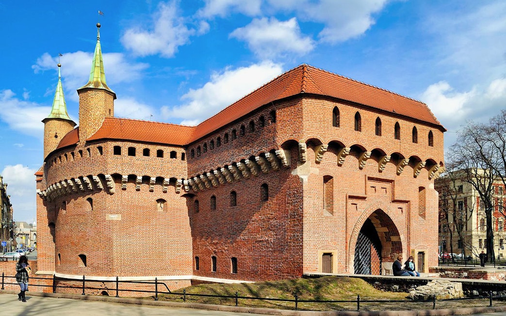 Kraków Barbican, medieval fortress with red brick walls and conical towers, Poland.