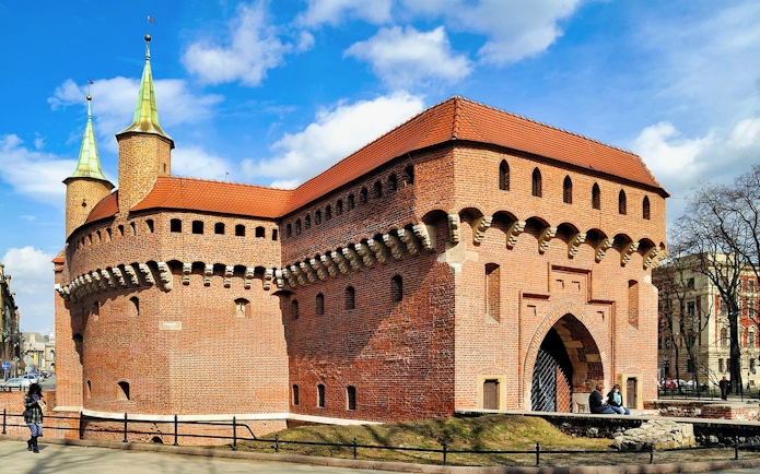 Kraków Barbican, medieval fortress with red brick walls and conical towers, Poland.
