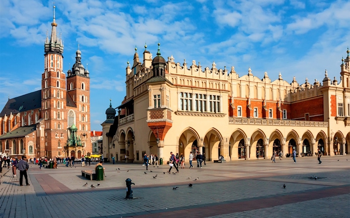 Cloth Hall in Krakow's Main Square with St. Mary's Basilica in the background.