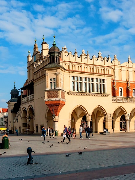 Cloth Hall in Krakow's Main Square with St. Mary's Basilica in the background.
