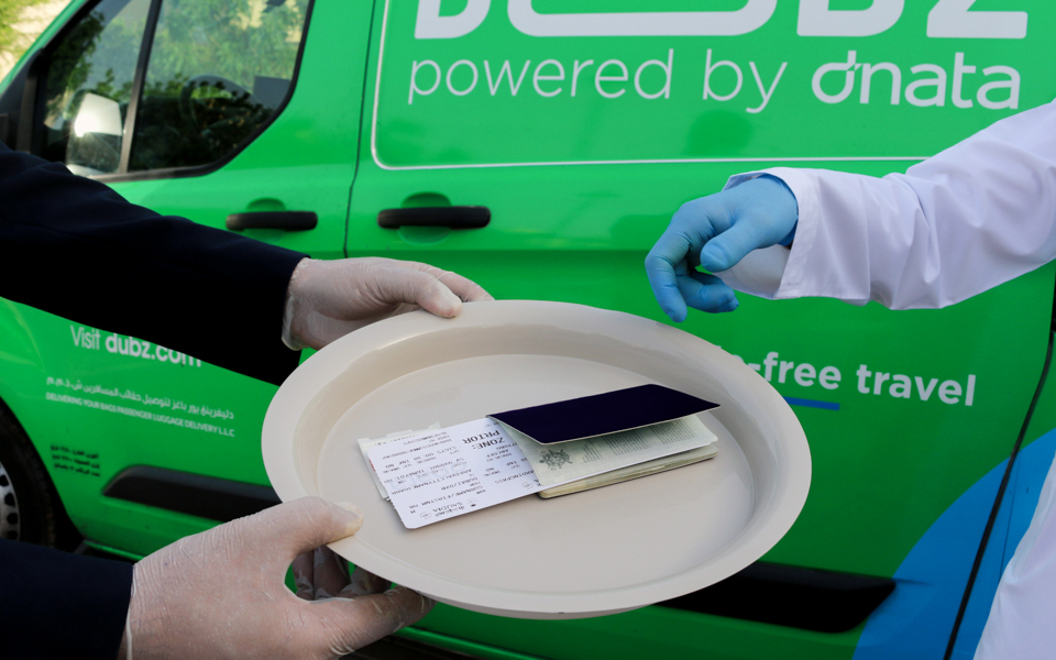 Passport and boarding pass on tray during DUBZ home check-in service.
