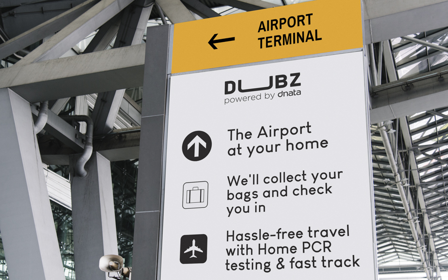 DUBZ service sign at airport offering home PCR tests and baggage collection.
