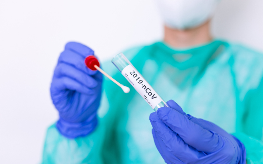 PCR test sample collection with swab and tube labeled 2019-nCoV.