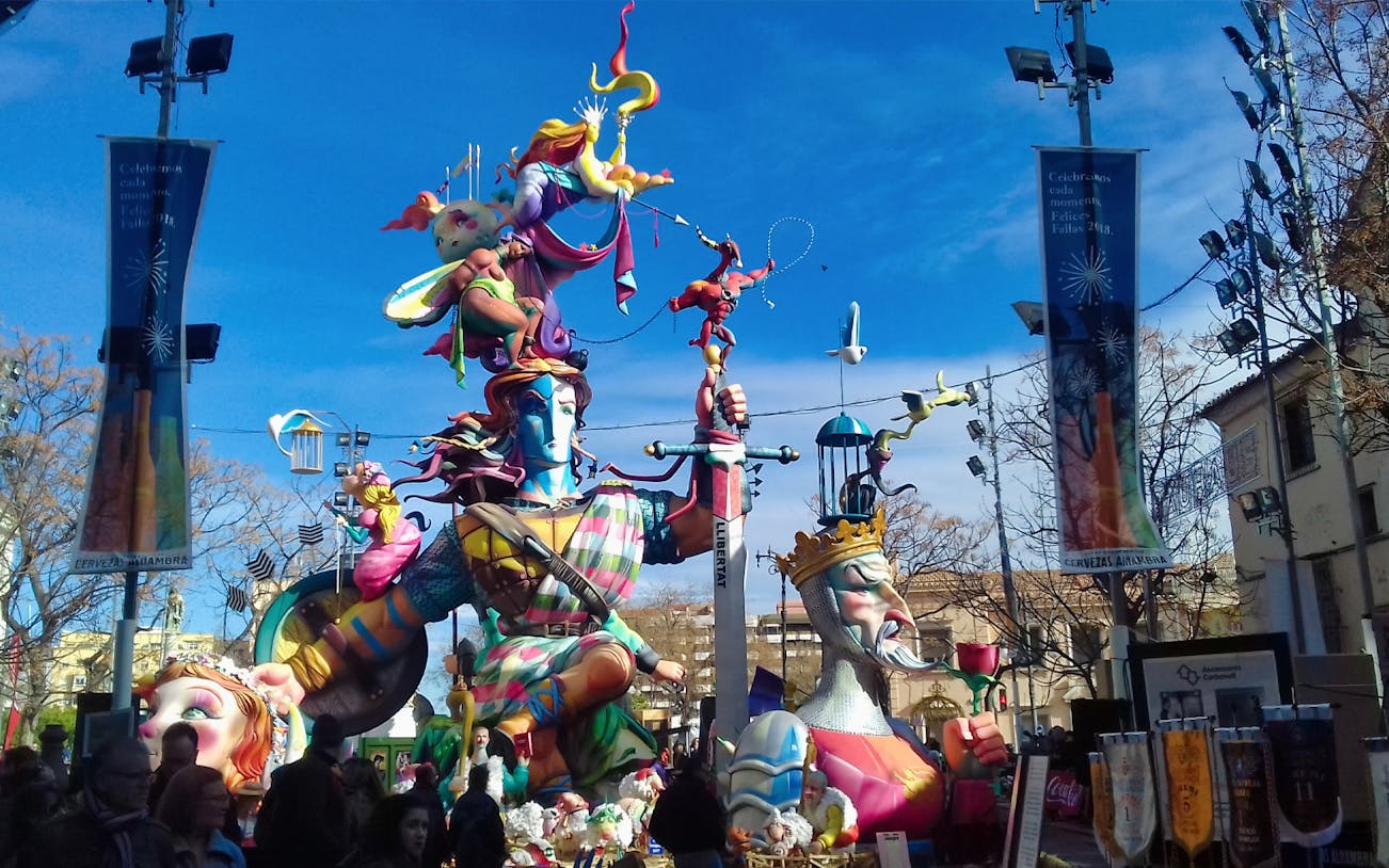 Colorful Fallas sculptures in Valencia Old Town during festival.