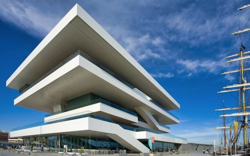 Valencia's modernist building at City of Arts and Sciences with a ship nearby.