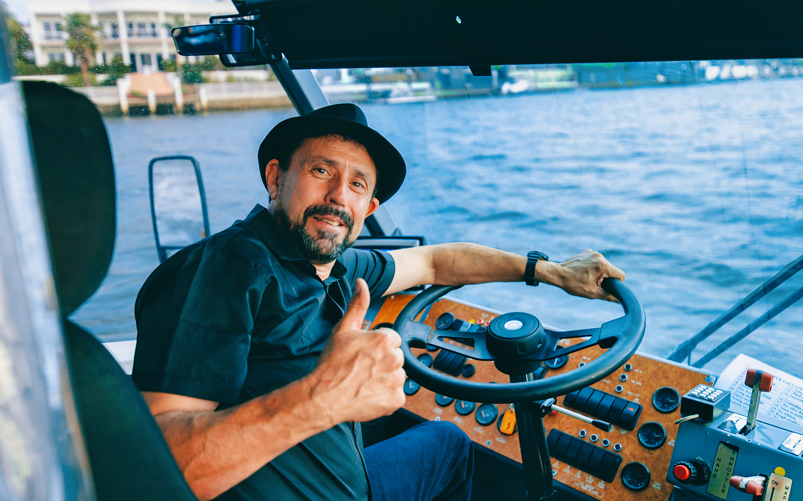 Man steering Aquaduck boat on Gold Coast tour.