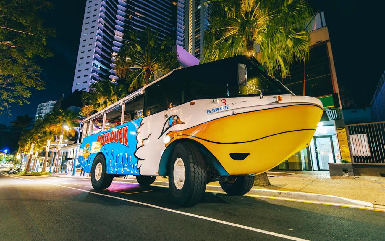 Aquaduck amphibious vehicle on Gold Coast street at night.