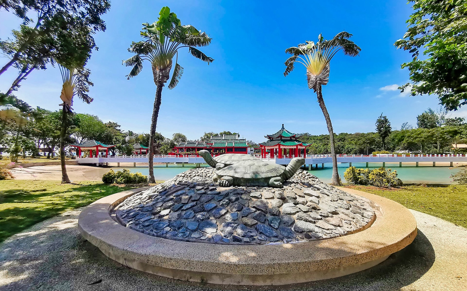 Ferry approaching Kusu Island and St John's Island, Singapore, with city skyline in the background.